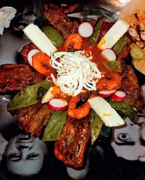 Platter of grilled shrimp, nopales, cheese and radish slices
