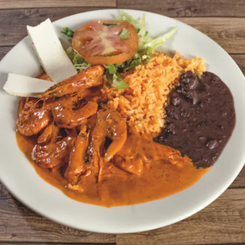 Meat in red-orange sauce with rice, black beans, tomato and cheese
