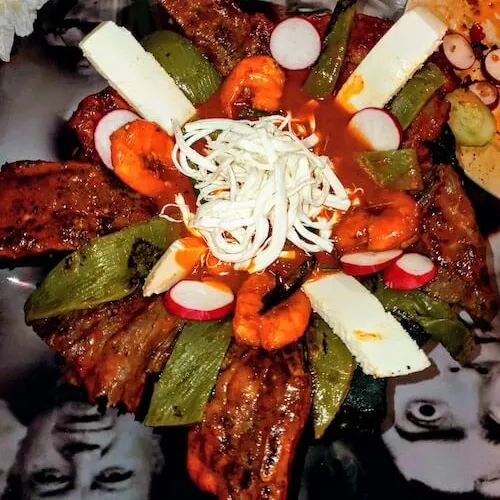 Platter of grilled shrimp, nopales, cheese and radish slices